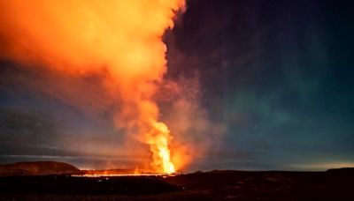 Northern lights shine over volcanic eruption