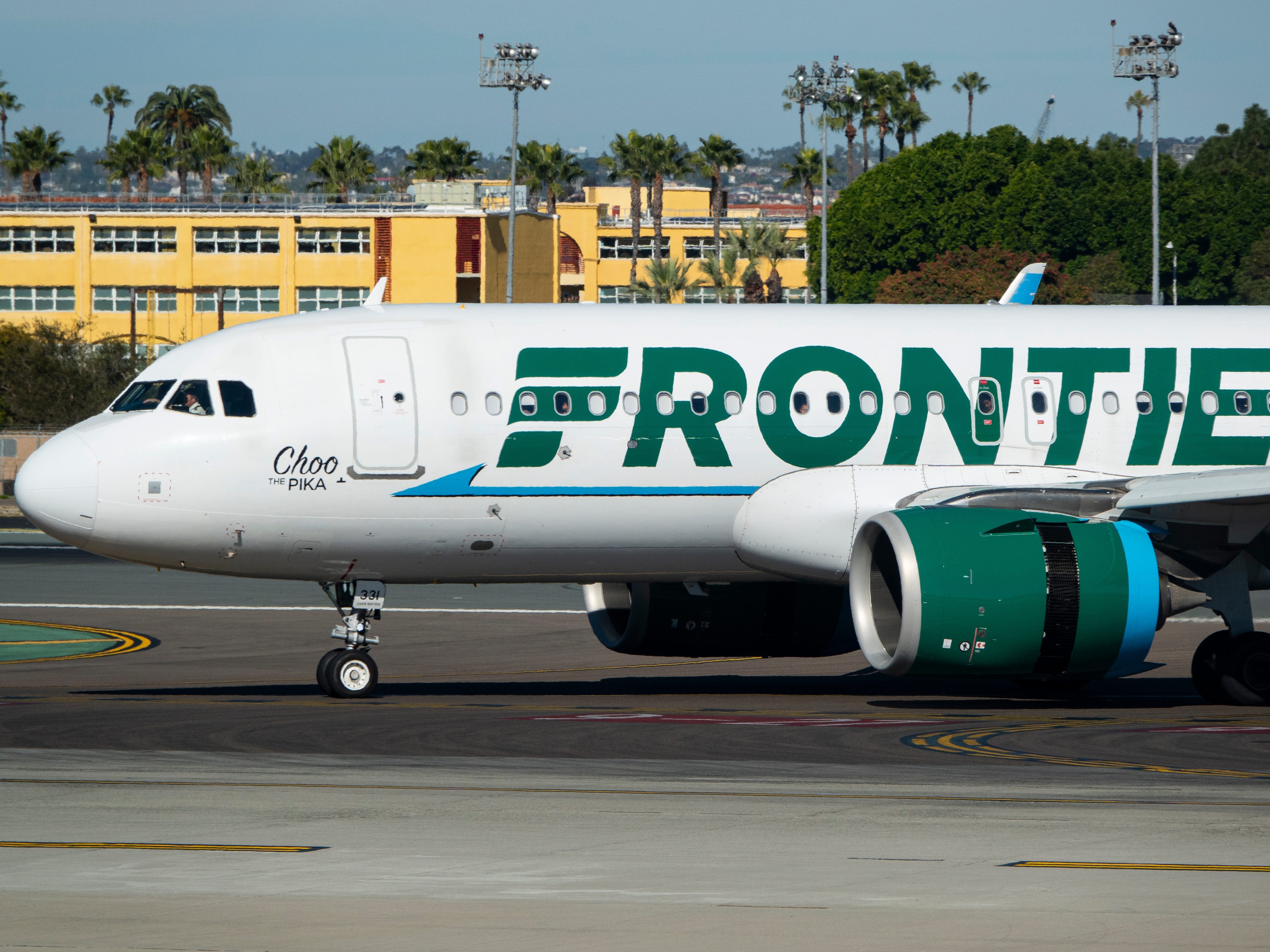 A Frontier passenger sat in an exit row was escorted off the plane in handcuffs after seemingly saying she wouldn't help in an emergency