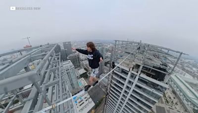 Daredevil seen on video walk tightrope between graffitied skyscrapers in downtown LA
