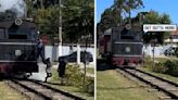Driver saves woman posing for photo from oncoming train by kicking her off tracks