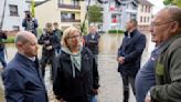 The German chancellor tours flooded regions in the southwest in a show of solidarity