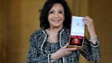 Shirley Bassey receives top honour from the King