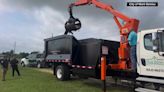 VIDEO: Public works, animal control crews in a Texas town use a grapple trash truck to move a massive alligator