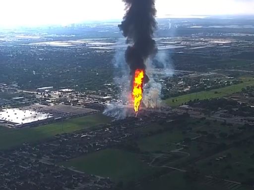 A pipeline explosion sends a towering pillar of flame over Houston's suburbs