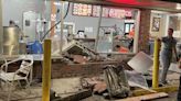 Woman charged after car crashes into restaurant on Broadway