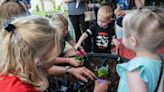 Kids pot flowers for moms at Floyd's Nursery on Rt. 60