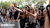 Mass tourism protesters squirt water at Barcelona tourists