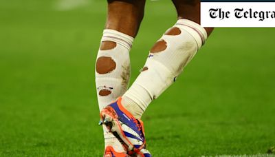 Why do Jude Bellingham and other footballers cut holes in their socks?