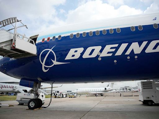 Boeing names its next CEO while posting a quarterly loss of more than $1.4 billion