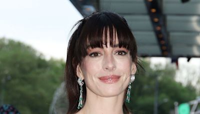 Anne Hathaway wears tight red dress as she attends The Idea of You premiere