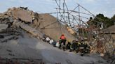 Rescuers contact some workers alive in the rubble of a deadly building collapse in South Africa