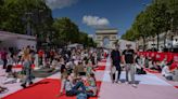 Paris' traffic-clogged Champs-Elysees turned into a mass picnic blanket for an unusual meal