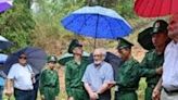 French Dien Bien Phu veterans Jean-Yves Guinard (R), Andre Mayer (C) and William Schilardi (2L) visit the former battleground with the help of Vietnamese soldiers