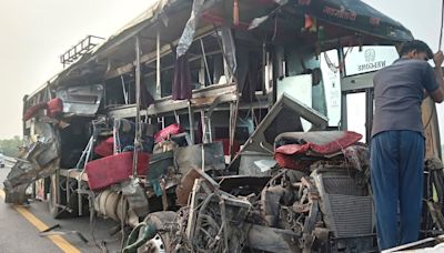 A double-decker bus collides with a milk truck, killing at least 18 people