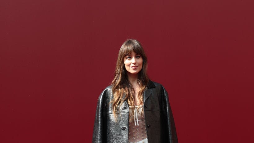 Dakota Johnson Wears transparent Black Bodysuit and Black Leather Jacket