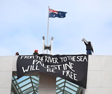 Pro-Palestinian protesters unfurl banners against Gaza war from roof of Australia’s parliament