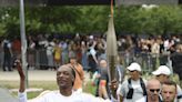 Snoop Dogg carries the Olympic torch before opening ceremony in Paris