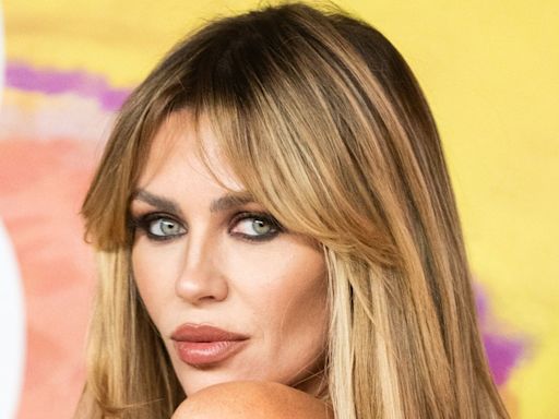 Abbey Clancy resembles a bronzed Bond girl in new beach photos