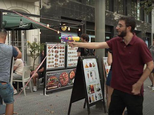 Protestors Spray Tourists with Water Guns During Demonstration Against Overtourism in Barcelona