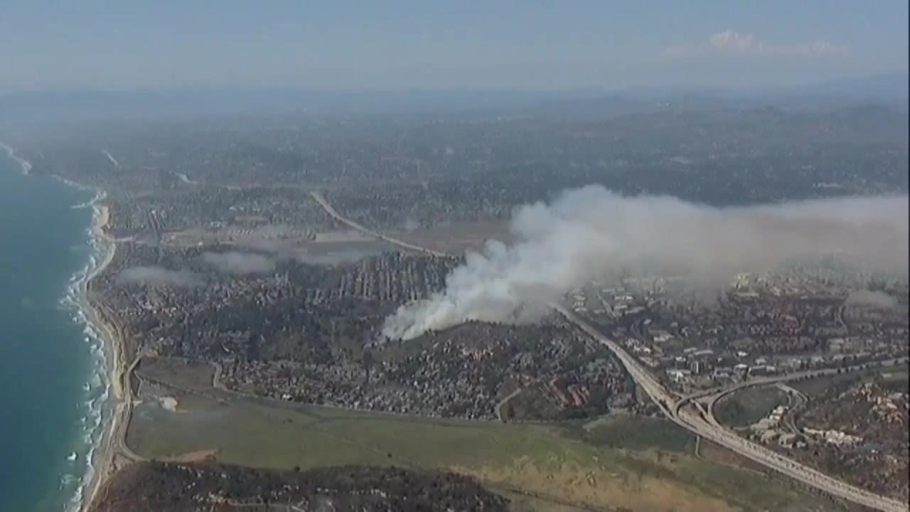 Evacuations, road closures lifted as crews work to douse brush fire in Del Mar Heights