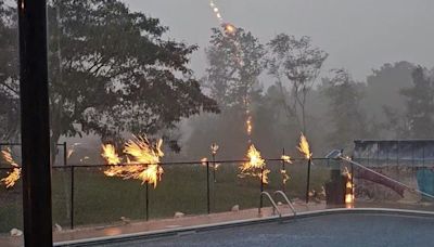 Pool fence erupts in sparks as lightning strikes nearby tree: 'I was in shock'