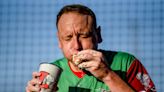 Competitive eater Joey Chestnut downs 13 olive burgers in 5 minutes before Lansing Lugnuts game