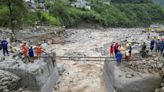 Rescuers search for dozens missing after flooding and a bridge collapse in China kill at least 25