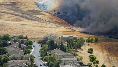 A grass fire burns adjacent to Crystyl Ranch in Concord, Calif., on Friday, June 29, 2018. On Thursday, March 14, 2024, California Insurance Commissioner Ricardo Lara...