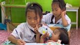 Viral: Fifth grader Thai girl feeds baby sister during class