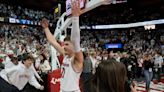 Wisconsin Badgers fans storm the Kohl Center court after wire-to-wire upset of Marquette