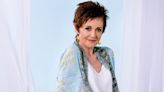 Neighbours star Jackie Woodburne urges "stay with us" as fans await new episodes