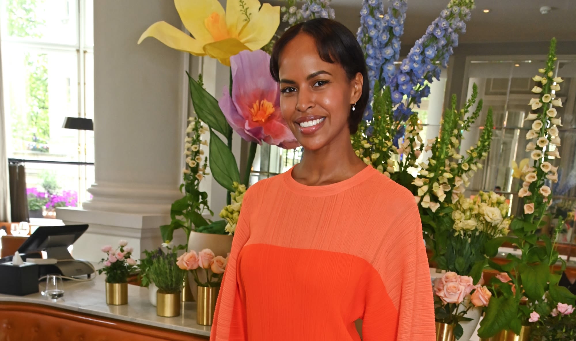 Sabrina Elba Pops in Vibrant Orange Stella McCartney Knit Dress With Voluminous Sleeves for London Luncheon Event