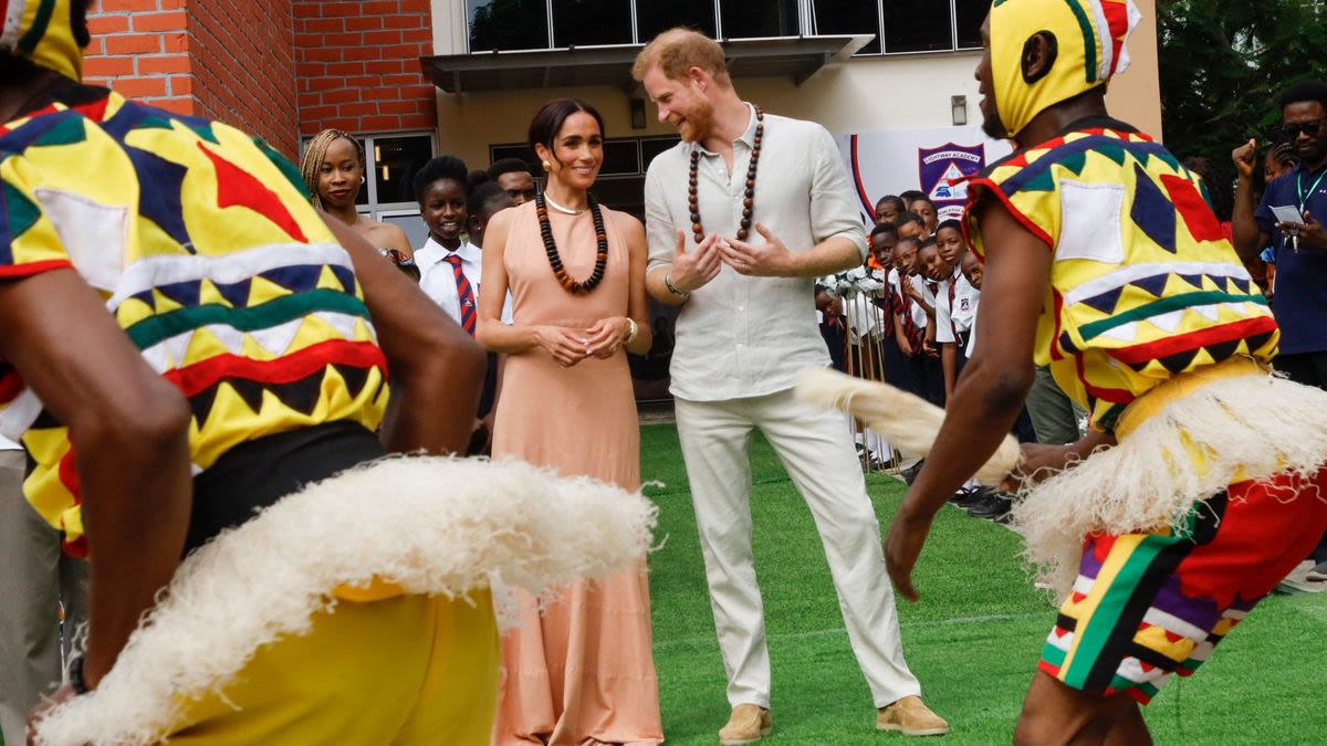 ...Meghan Markle, In a Proud Wife Moment, Says of Prince Harry “You See Why I’m Married To Him?” While at an...