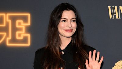 Anne Hathaway puts a glamorous twist on the long black coat