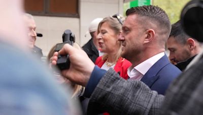 Tommy Robinson arrives at court accompanied by Katie Hopkins