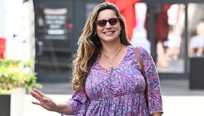 Kelly Brook puts on a leggy display in a purple mini dress