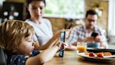 Children glued to their phones at meal time face obesity risk