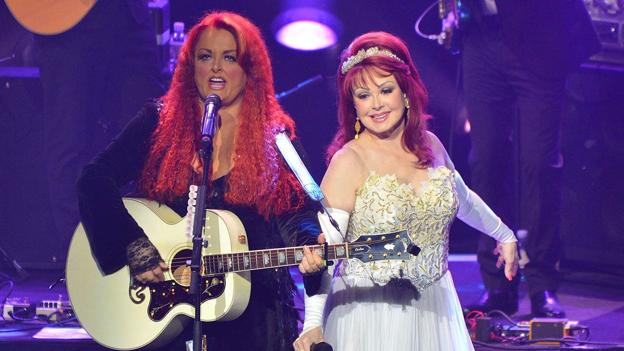 Wynonna Judd says she still talks to late mother Naomi Judd when she's performing onstage