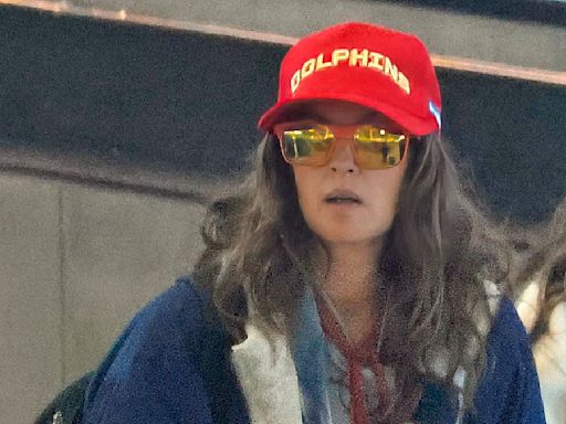 Drew Barrymore goes incognito as she departs Brisbane with daughters