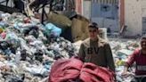 A man uses a wheelbarrow to move belongings in the Gaza City neighbourhood of Zeitun