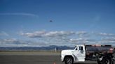 An aircraft takes off above a new unleaded fuel truck prior to director of the Rocky Mountain Metropolitan Airport Paul Anslow introducing the transition to unleaded fuel program at Rocky Mountain...