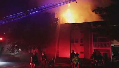Massive fire rips through apartment building in Worcester, traps 2 people inside