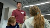 IT professional volunteers time to help 4th-grade students in school tech program