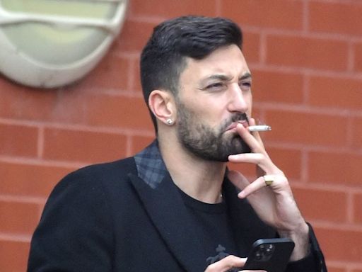 Giovanni Pernice looks downcast as he smokes a cigarette