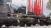 Putin shows off his spoils of war with captured British armoured cars