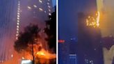 Towering inferno with huge hotel block on fire as flames drip onto street