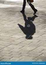 Shadow of man walking stock photo. Image of street, shadow - 79174774