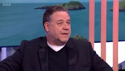 Russell Crowe's appearance distracts fans as he explains why he's a Leeds United diehard and part owner