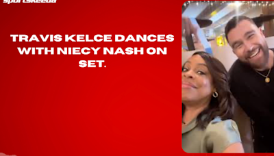 Travis Kelce dances with Niecy Nash on set.