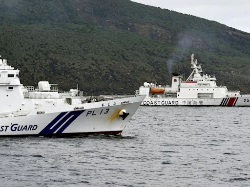 Chinese armed vessels patrol waters around disputed islands, angering Japan